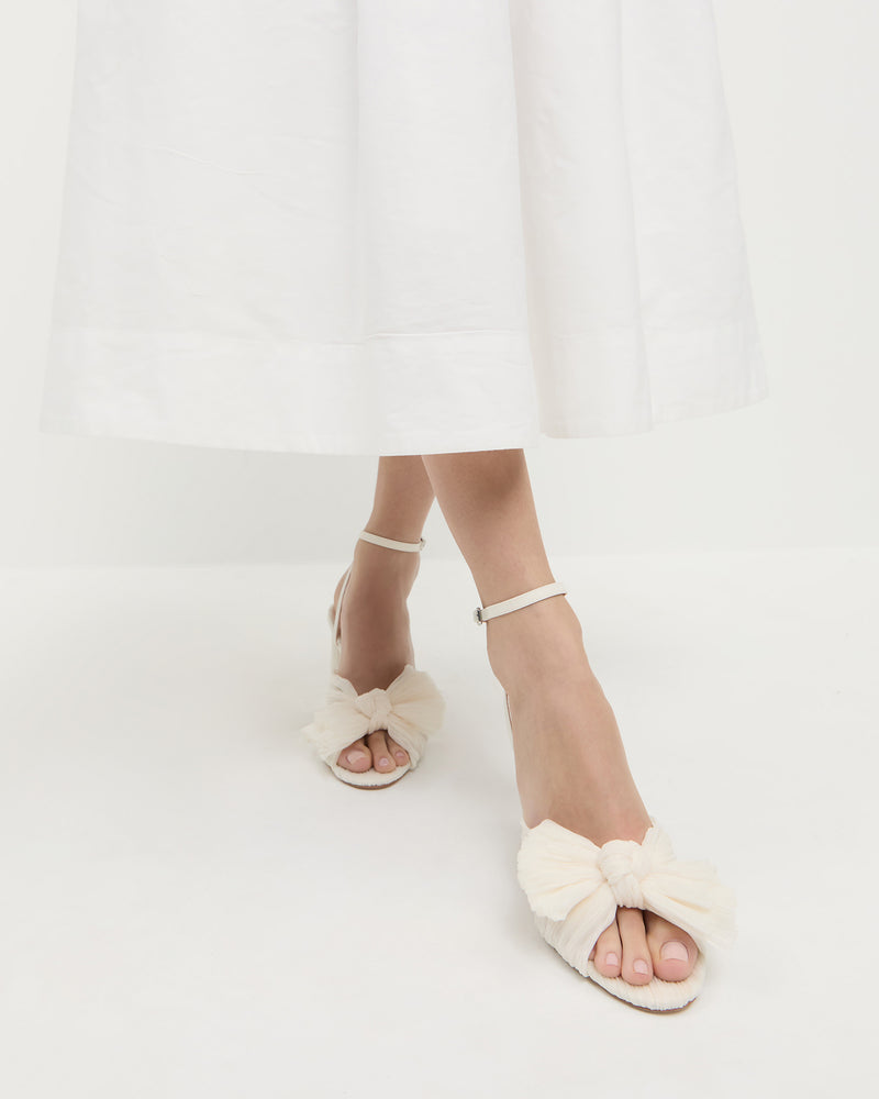 Camellia Pearl Pleated Bow Heel in pearl pleated fabric and Estelle Dress in white cotton.