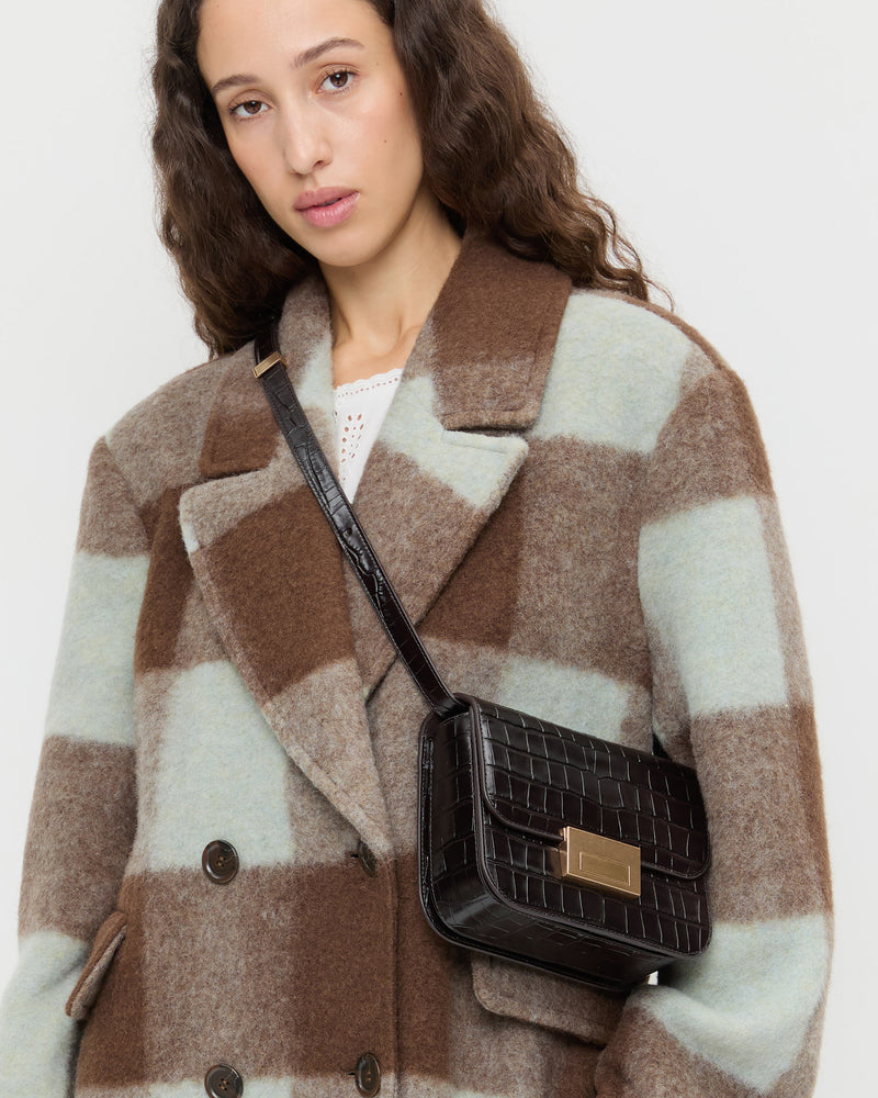 Desi Crocodile Leather Crossbody in ebony crocodile embossed leather and Finley Wool Coat in dark brown and mint gingham wool.