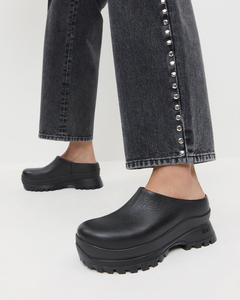Gemma Black Leather Lug Mule in black pebbled leather and Winona Denim Barrell Pant in washed black.