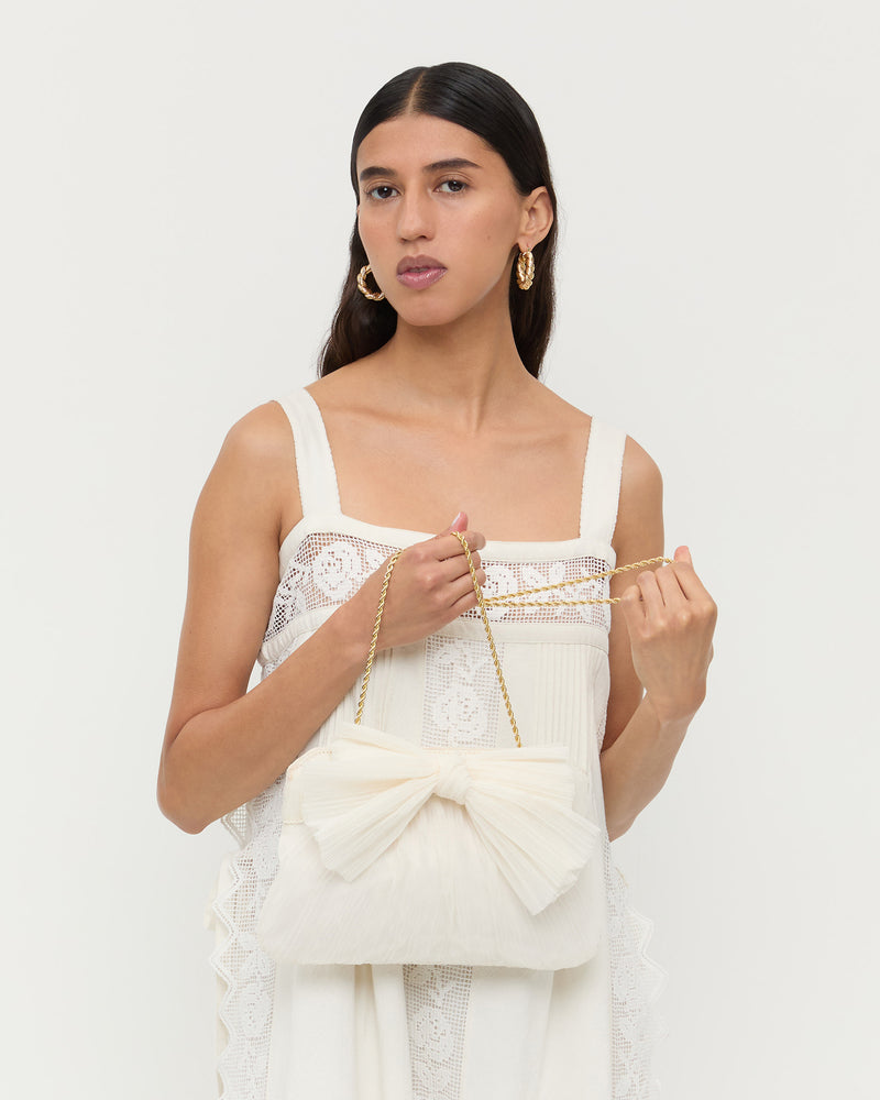 Rayne Pearl Bow Clutch in pearl fabric
