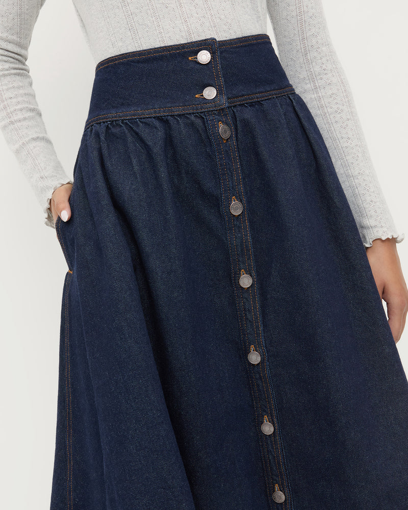 Ruthie Denim Skirt in dark blue denim and Lolo Pointelle Long-Sleeve Top in grey cotton.