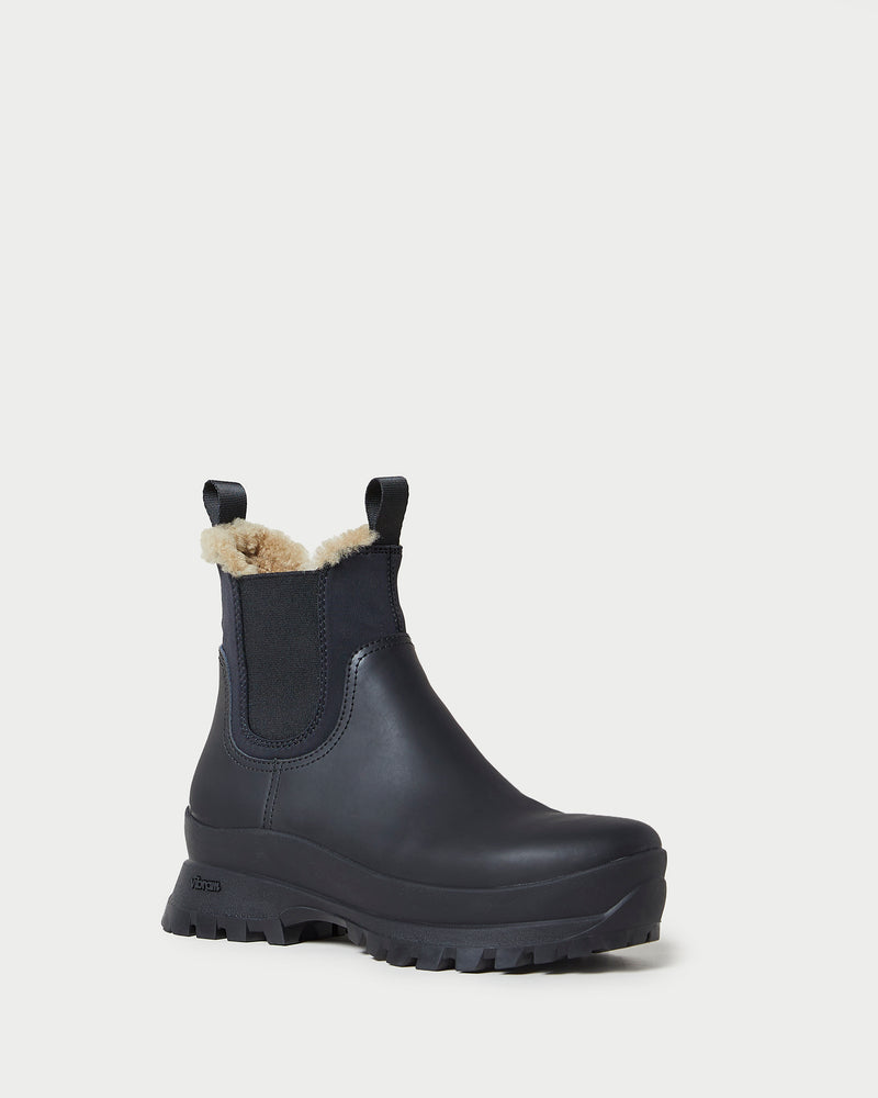 Tara Black Shearling-Lined Boot in black leather.