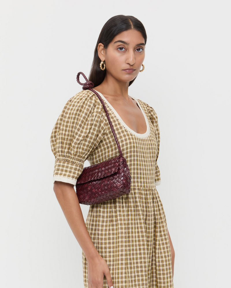 Vinnie Maroon Woven Leather Crossbody in maroon woven leather and Gillian Puff Sleeve Dress in brown plaid.