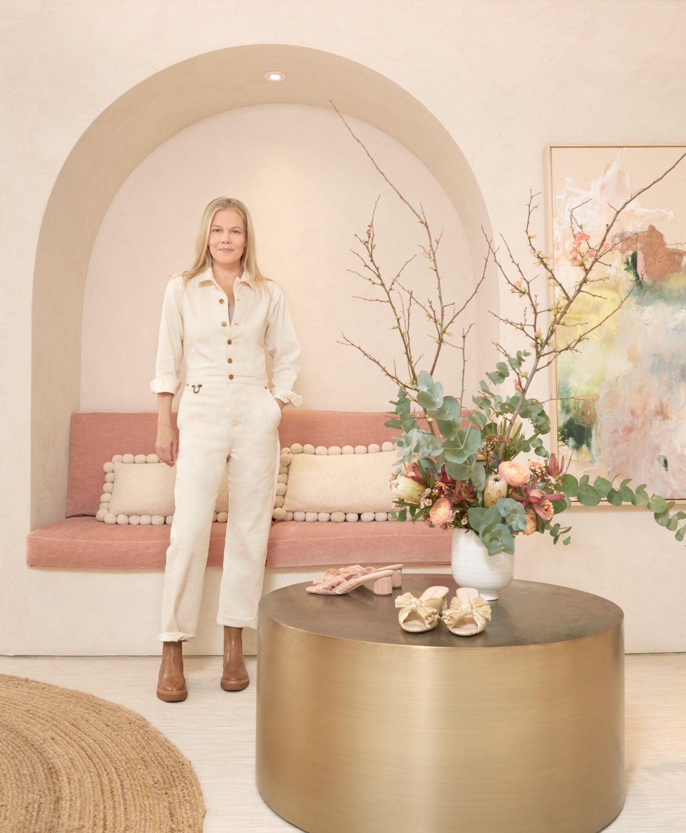 Jessie Randall stands in her Soho store next to a table with shoes and flowers on it.