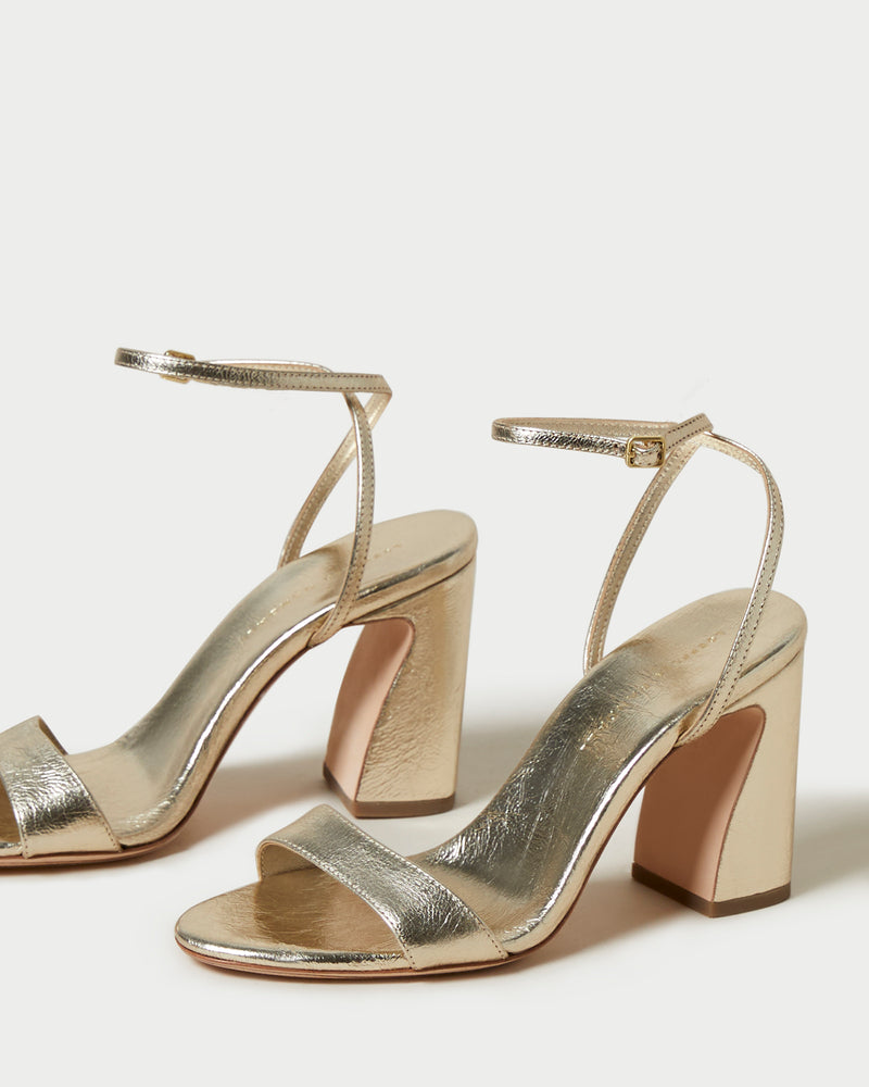 Malia Champagne Curved-Heel Sandal in metallic champagne leather