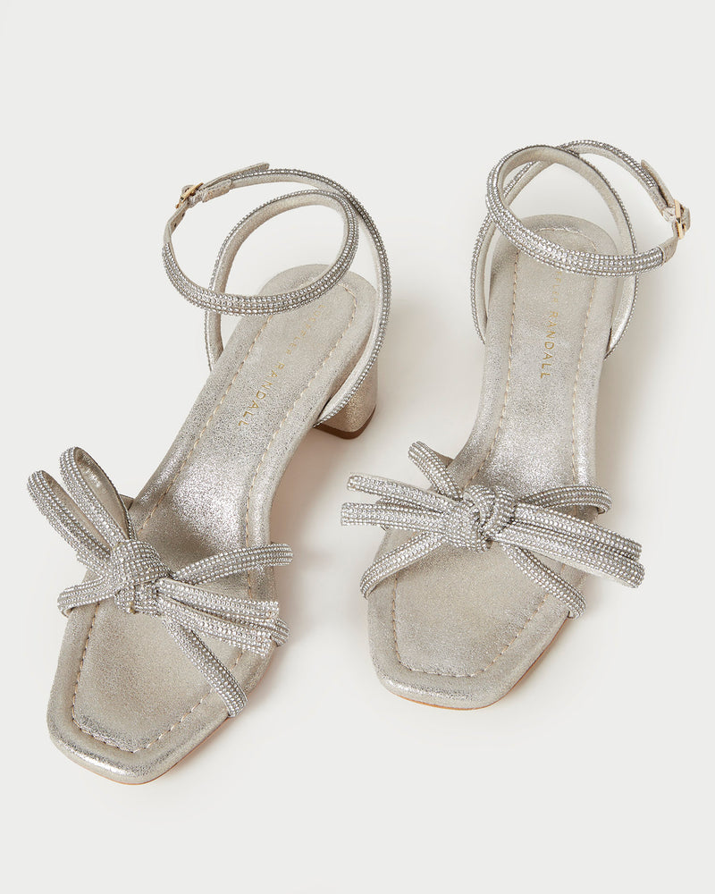 Mikel Cappuccino Bow Mid-Heel Sandal in light champagne sparkle suede