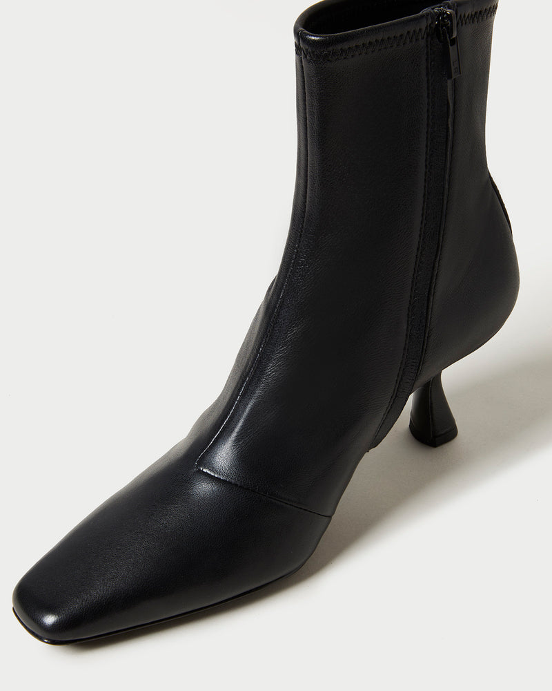 Thandy Black Leather Curved Heel Bootie in black leather.