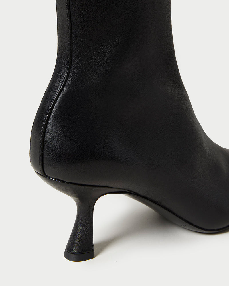 Thandy Black Leather Curved Heel Bootie in black leather.