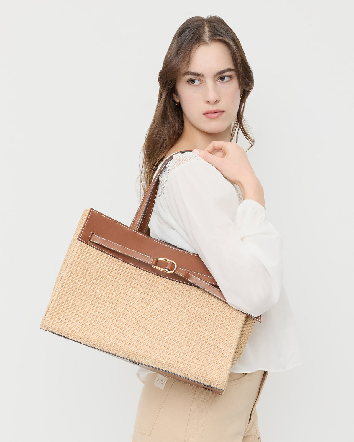Aidan Natural Straw Work Tote in chunky woven fabric, Hattie Top in cream cotton, and Demi Embroidered Pant in tan cotton.