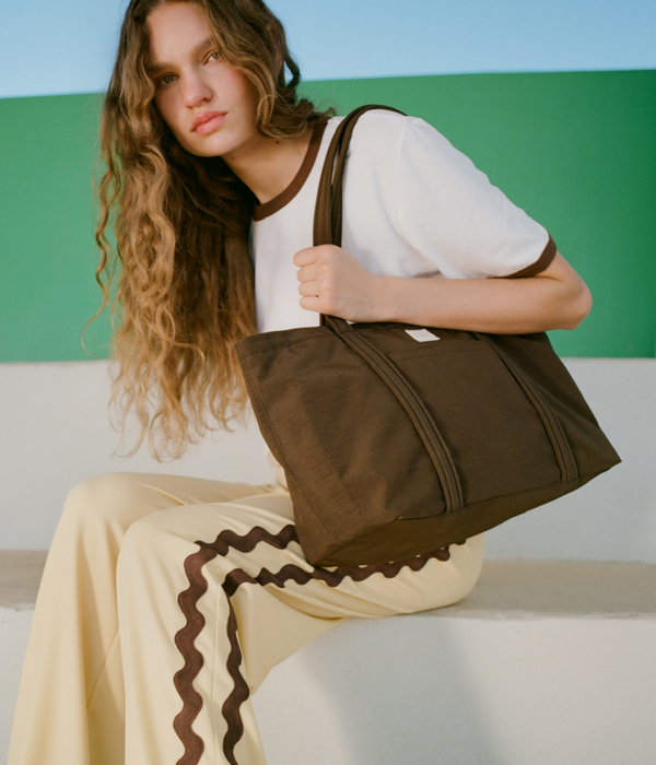 Harly Tee in white cotton, Venus Track Pant in butter nylon, and Mira Chocolate Everyday Tote - Loeffler Randall