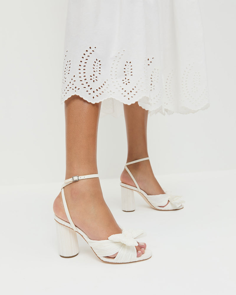 Camellia White Pleated Bow Heel in white fabric and Thelma Eyelet Dress in white cotton.
