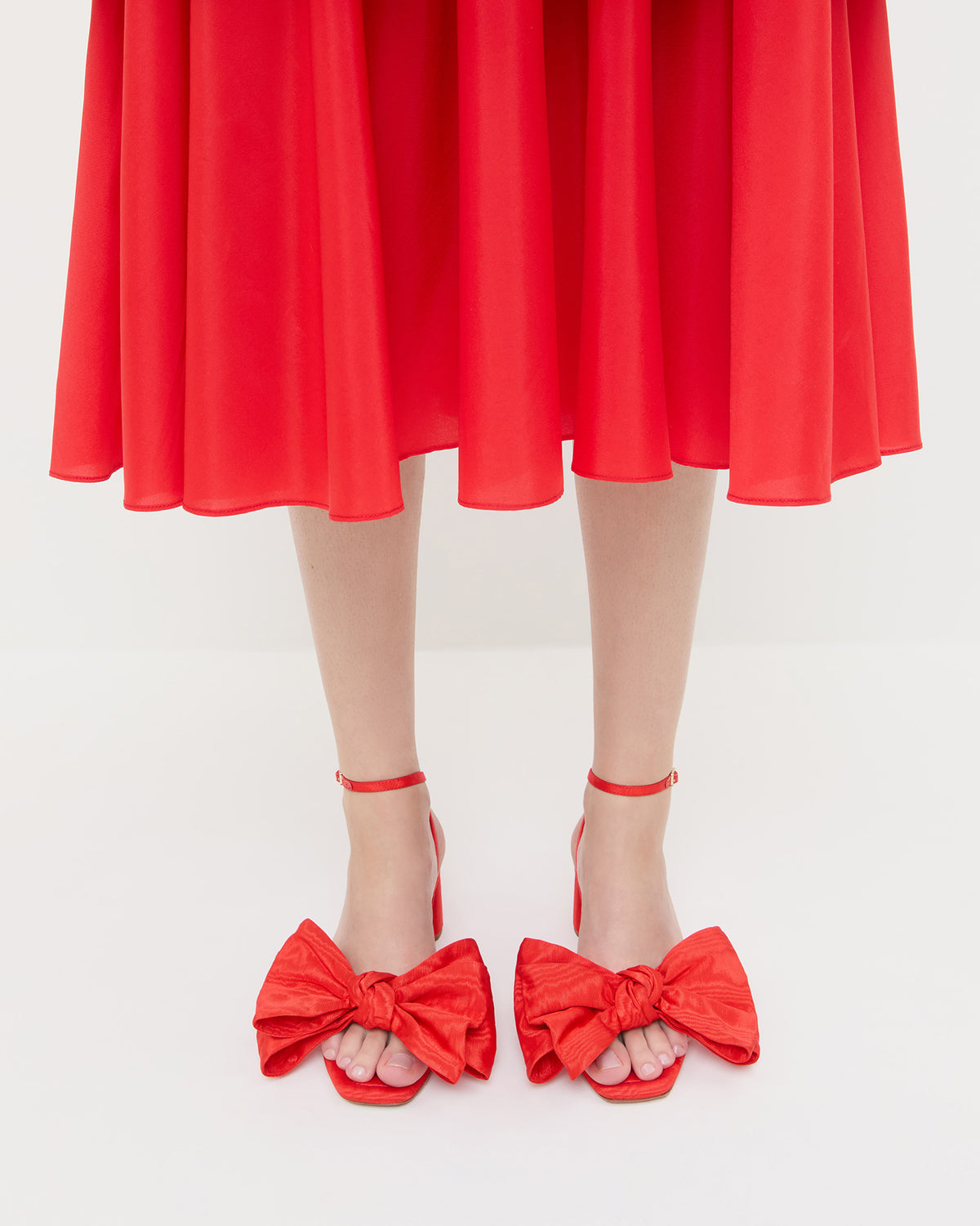 Carmen Red Moiré Bow Sandal in red moiré and Celestina Dress in red taffeta.
