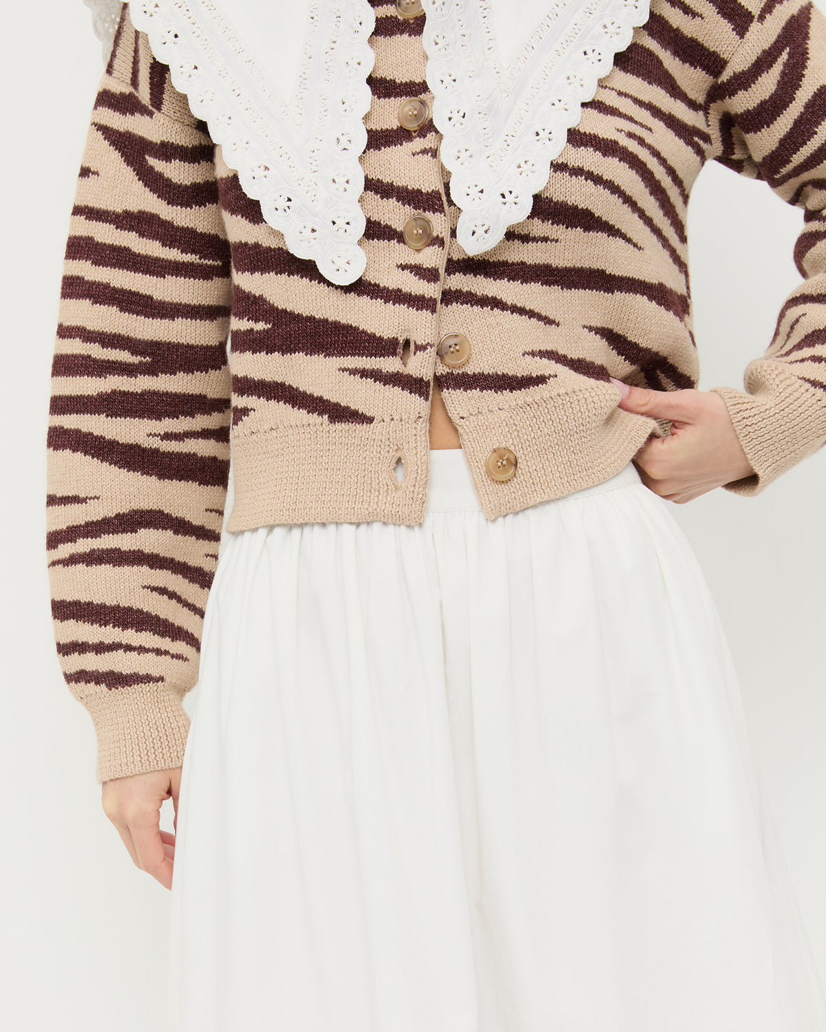 Delaney Midi skirt in cream cotton with lace detailing, Ken Shirt and white cotton, and Bodhi Cardigan in zebra wool.