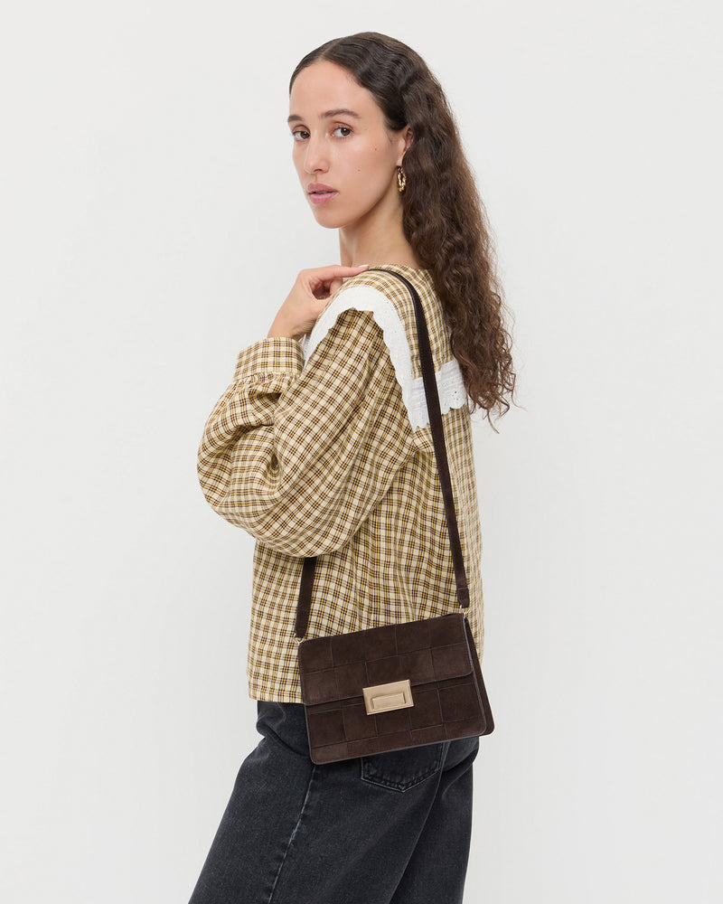 Delphine Brown Suede Shoulder Bag, Ken Shirt in brown plaid, and Everett Denim Shorts in washed black.