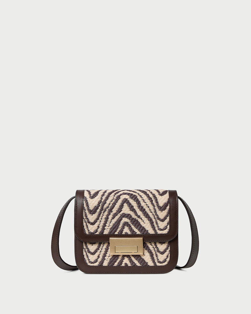 Desi Zebra Straw Crossbody in zebra woven cotton fabric with dark brown leather.