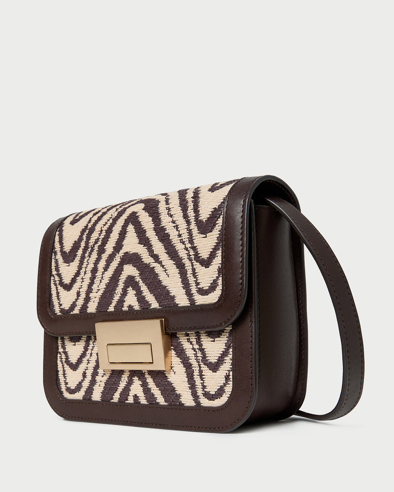 Desi Zebra Straw Crossbody in zebra woven cotton fabric with dark brown leather.