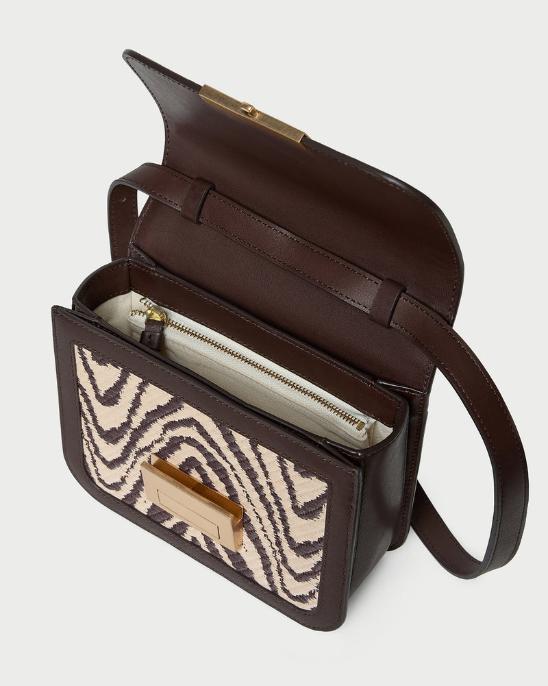 Desi Zebra Straw Crossbody in zebra woven cotton fabric with dark brown leather.