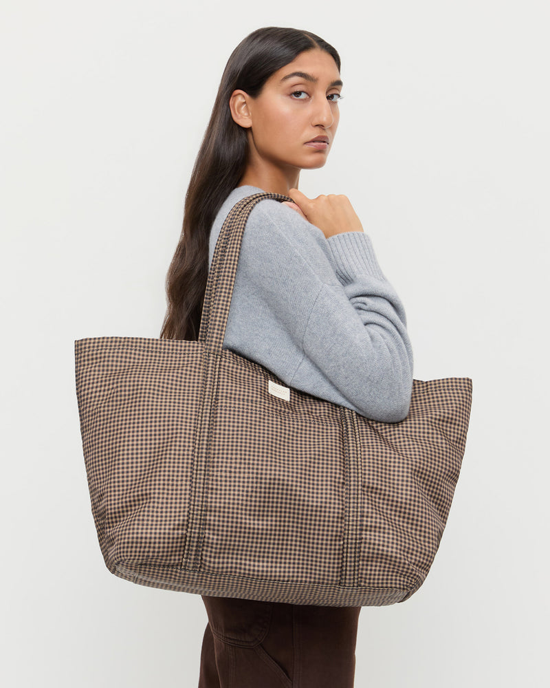Dina Brown/Black Check Travel Tote in brown and black check nylon, Lana Cashmere Sweater in grey cashmere, and Molly Workweark Jean in brown denim.
