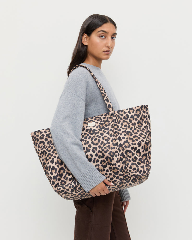 Dina Brown/Leopard Travel Tote in brushed leopard nylon, Lana Cashmere Sweater in grey cashmere, and Molly Workweark Jean in brown denim.