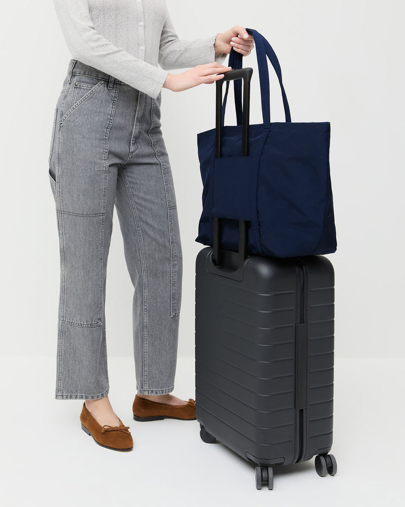Dina Navy Travel Tote in navy nylon, Lolo Pointelle Long-Sleeve Tee in grey cotton, Molly Workwear Jean in grey denim, and Noelle Cacao Suede Ballet Flat.