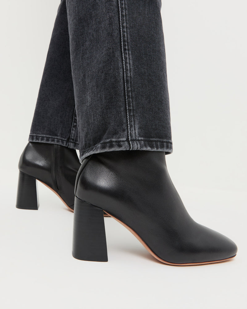 Elise Black Leather Stretch Ankle Bootie in black leather and Molly Workwear Jean in washed black denim.