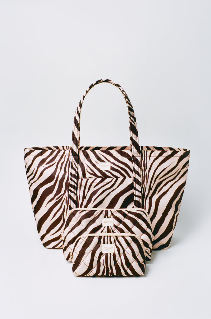 Frances Zebra Cosmetic Pouch in zebra print nylon, Dina Zebra Travel in zebra print nylon, and Georgette Zebra Mini Cosmetic Pouch in zebra print nylon.