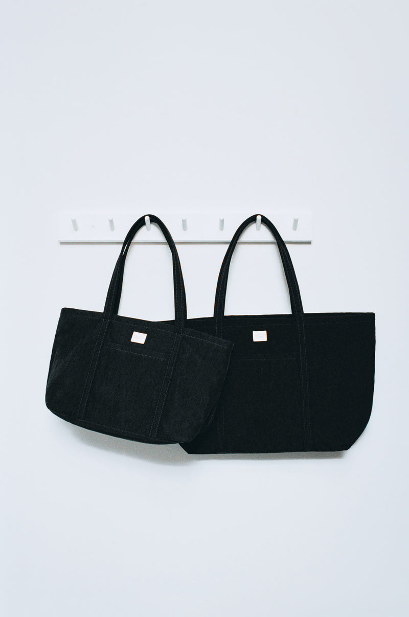 Mira Black Everyday Tote in black nylon and Dina Black Travel Tote in black nylon.