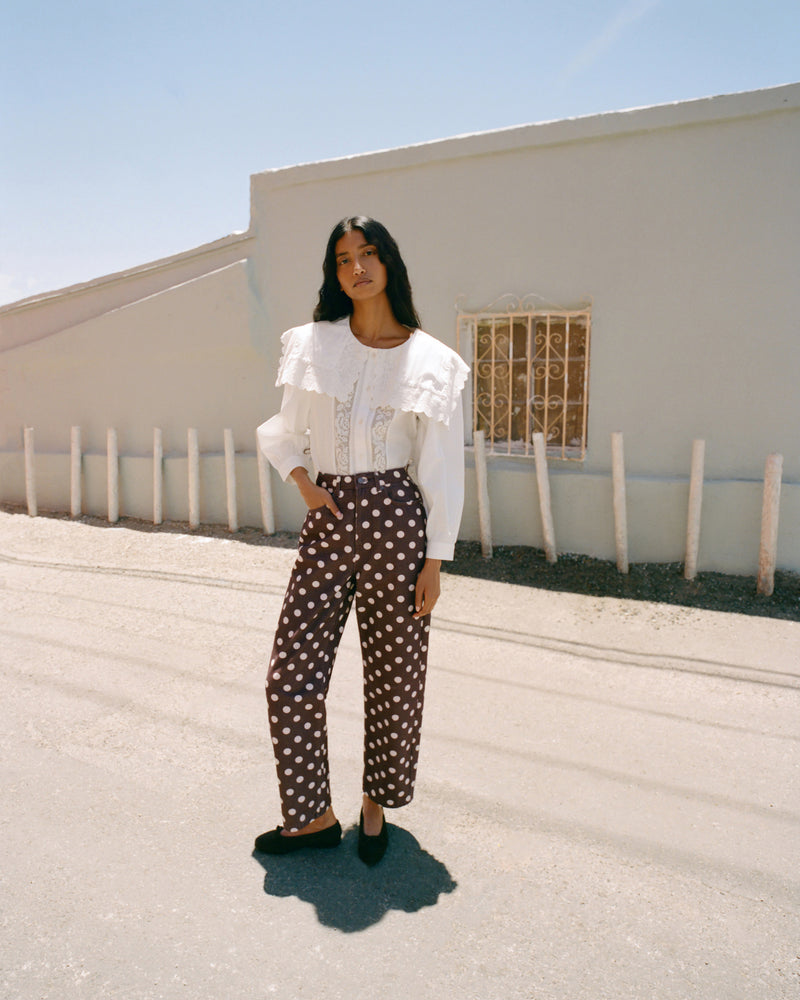 Noelle Brown Suede Ballet Flat in brown suede, Gail Top in white cotton, and Winona Denim Pant in brown and cream polka dot denim.