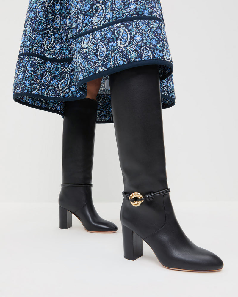 Goldy Black/Gold Leather Tall Boot in black leather with a gold accent and Ainsley Dress in blue floral.