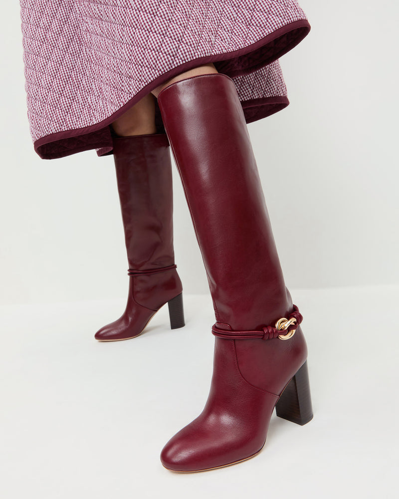 Goldy Wine/Gold Leather Tall Boot in wine red leather and a gold accent and Clara Quilted Skirt in maroon gingham.