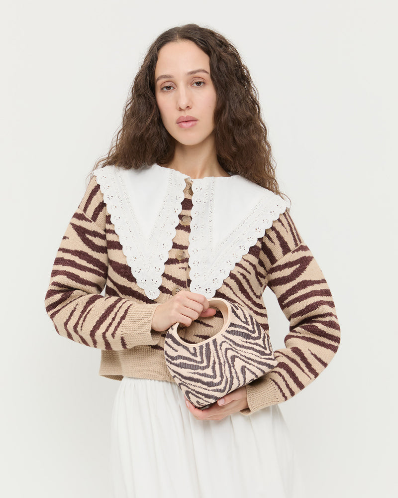 Kenzie Zebra Mini Bag in woven cotton, Bodhi Cardigan in zebra wool, Ken Shirt in white cotton, and Delaney Skirt in white cotton.