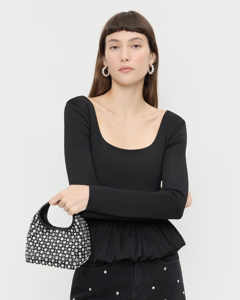Kenzie Black/Crystal Mini Bag in black satin with crystal accents, Posie Peplum Top in black jersey, and Winona Denim Pant in black denim with crystal accents.