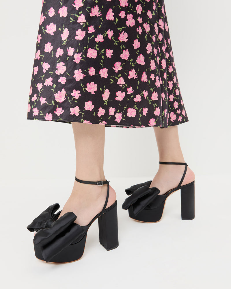 Kiki Black Satin Platform Sandal in black satin and Mandy Skirt in black rosette textured fabric.