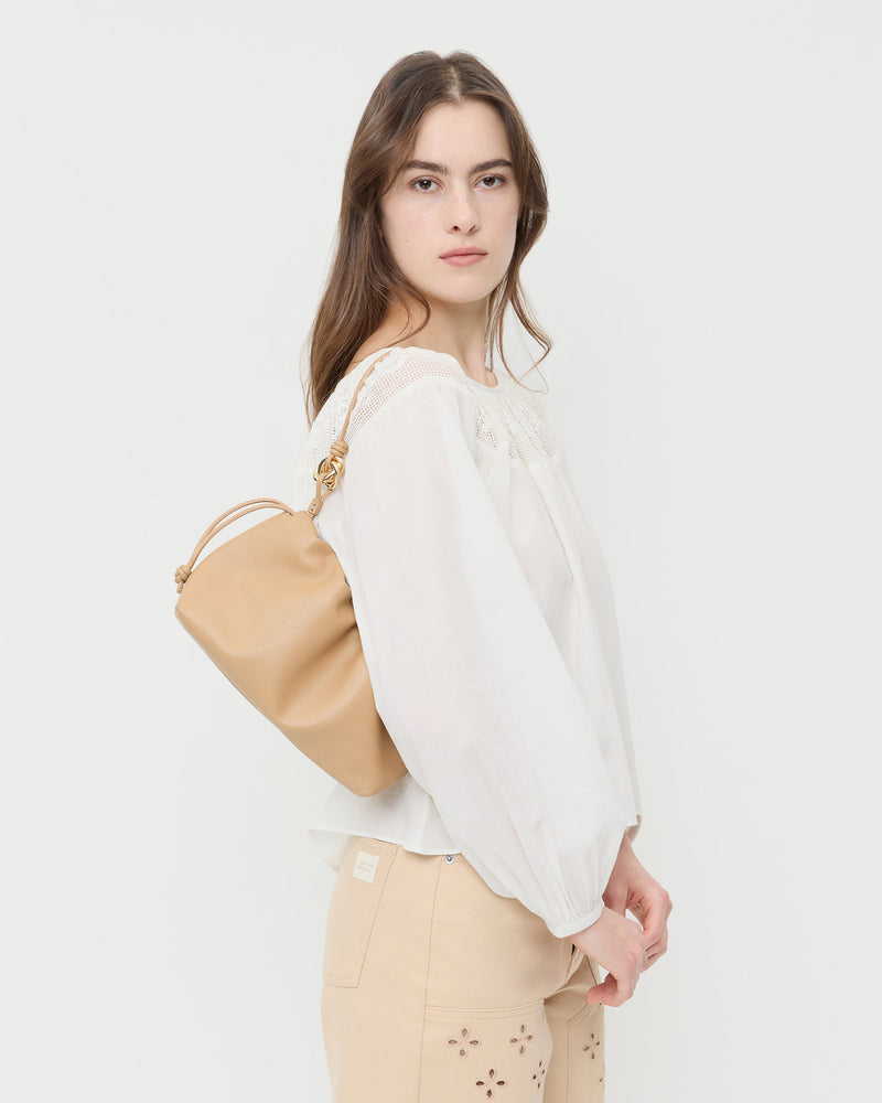 Kiri Khaki Leather Shoulder Bag in khaki tan nappa leather, Hattie Top in white cotton, and Demi Embroidered Pant in tan cotton.