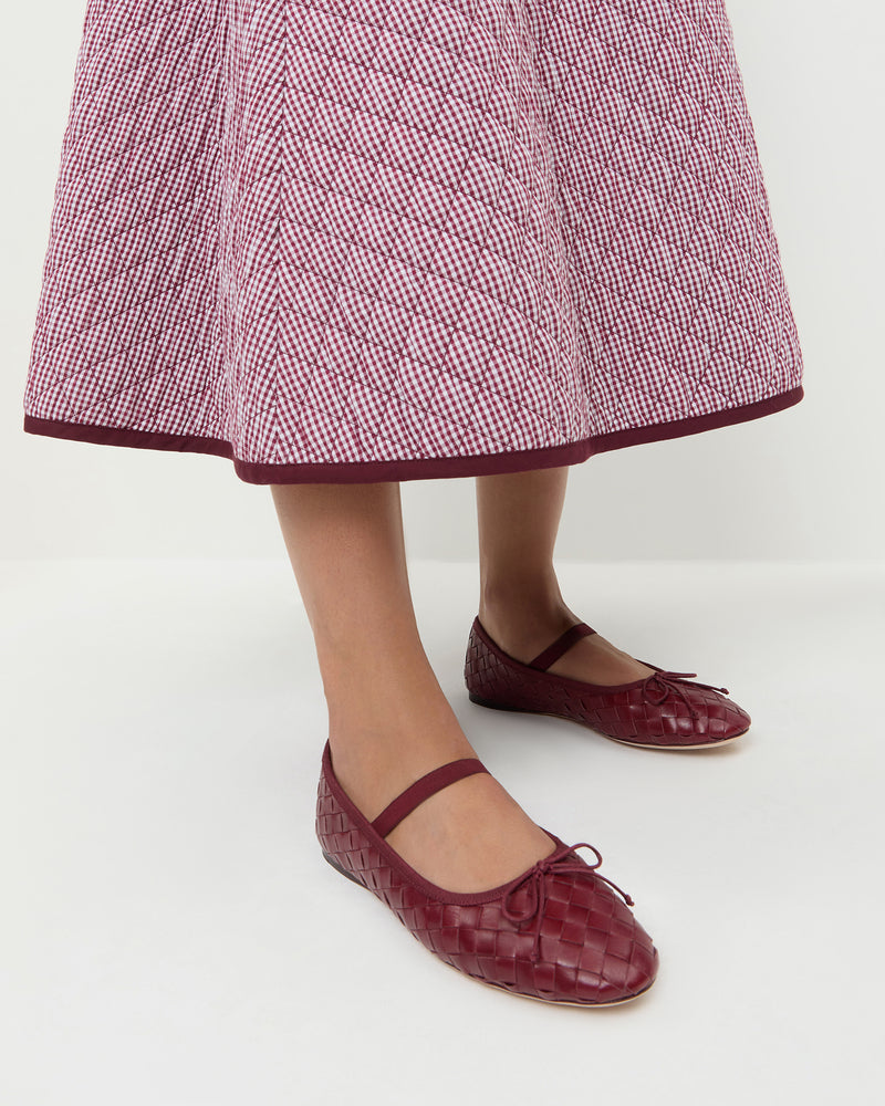 Leonie Wine Woven Ballet Flat in red wine woven leather and Clara Quilted Skirt in maroon gingham.