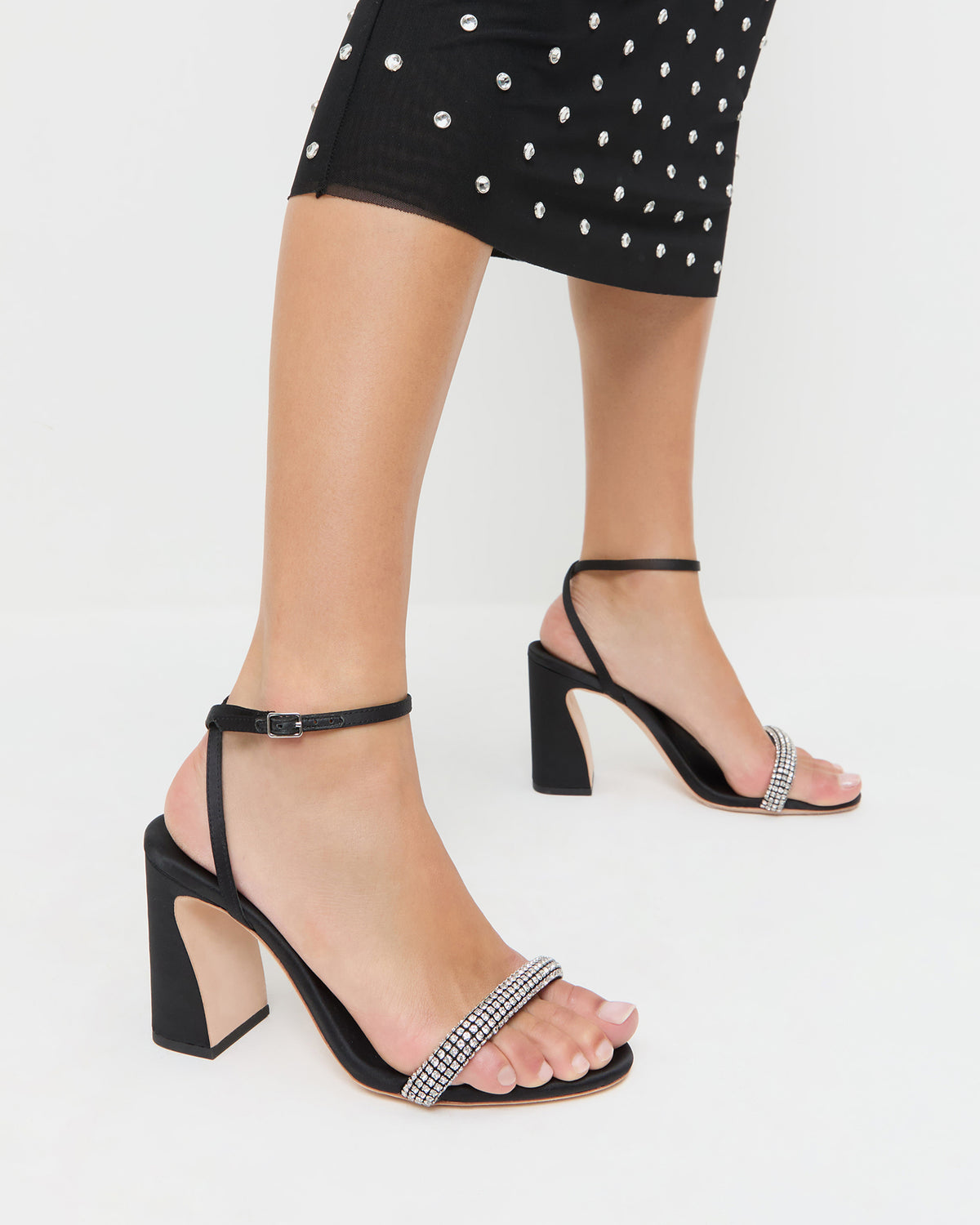 Malia Black/Diamond Curved-Heel Sandal in black satin with crystal accents and Nuri Dress in black mesh with crystal accents.