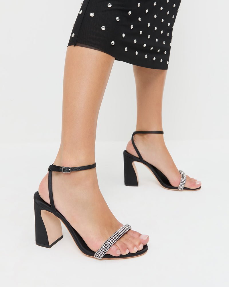 Malia Black/Diamond Curved-Heel Sandal in black satin with crystal accents and Nuri Dress in black mesh with crystal accents.
