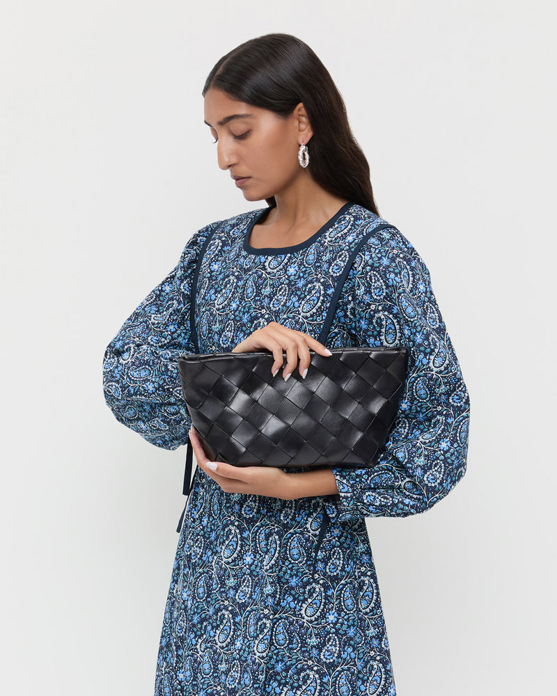 Melina Black Woven Leather Clutch in black woven leather and Ainsley Dress in blue floral.