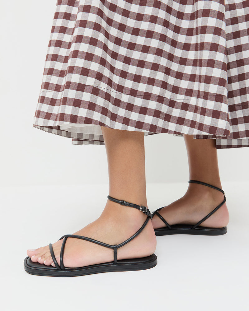 Noor Black Leather Flat Sandal in black leather and Estelle Dress in brown gingham cotton.