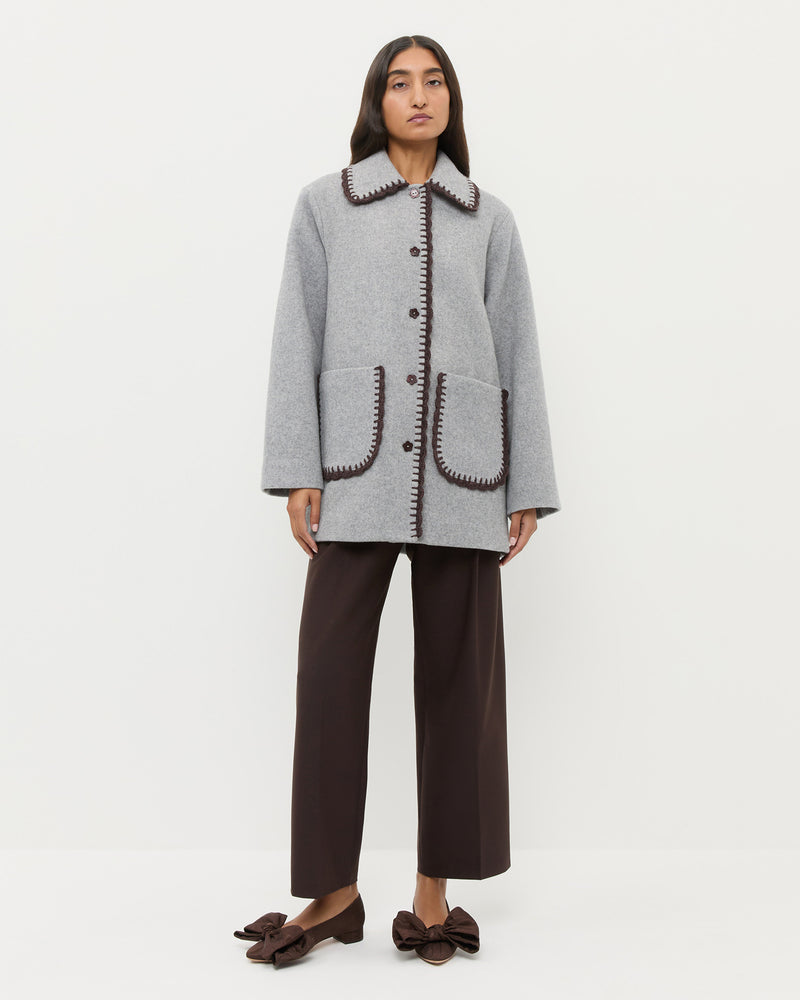 Patsy Wool Coat in grey wool with dark brown crochet trim.