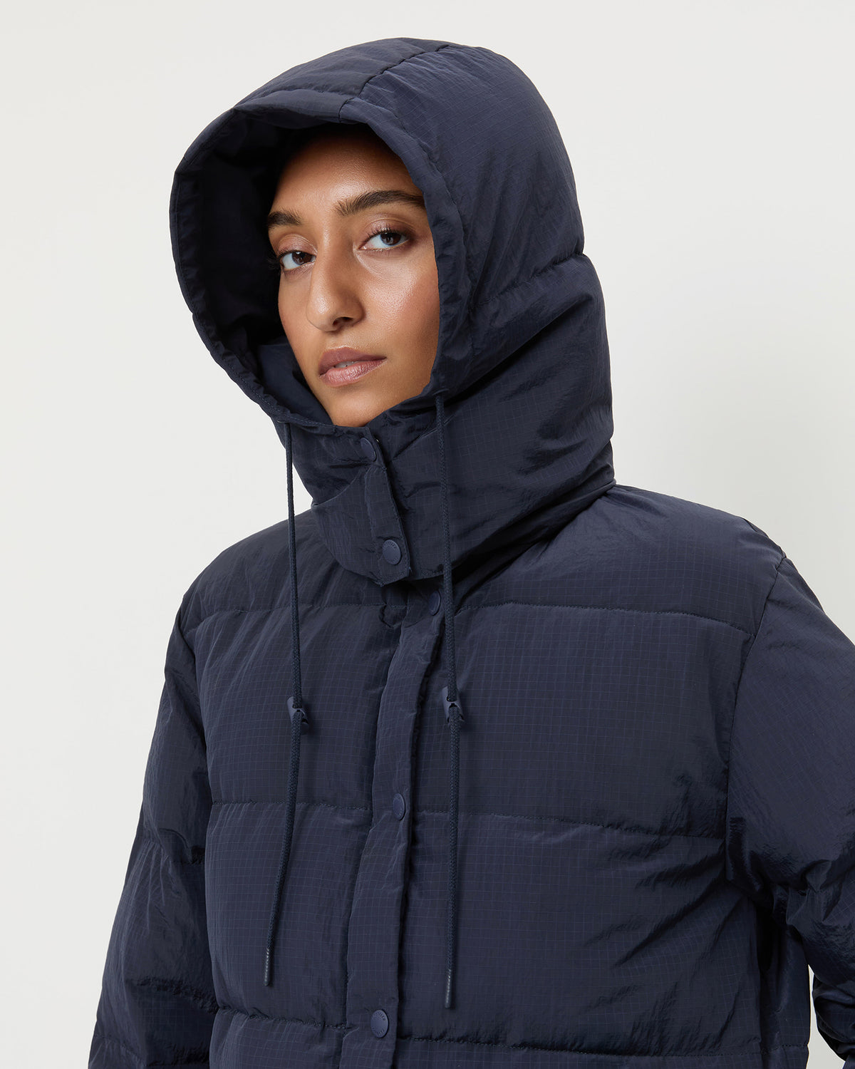 Pippa Puffer Coat in navy nylon and brown wool.