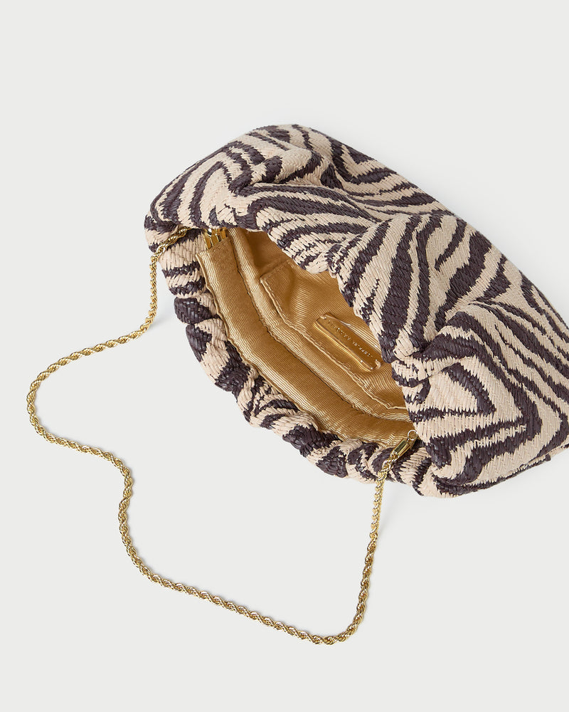 Serena Zebra Gathered Clutch in zebra print woven straw fabric.