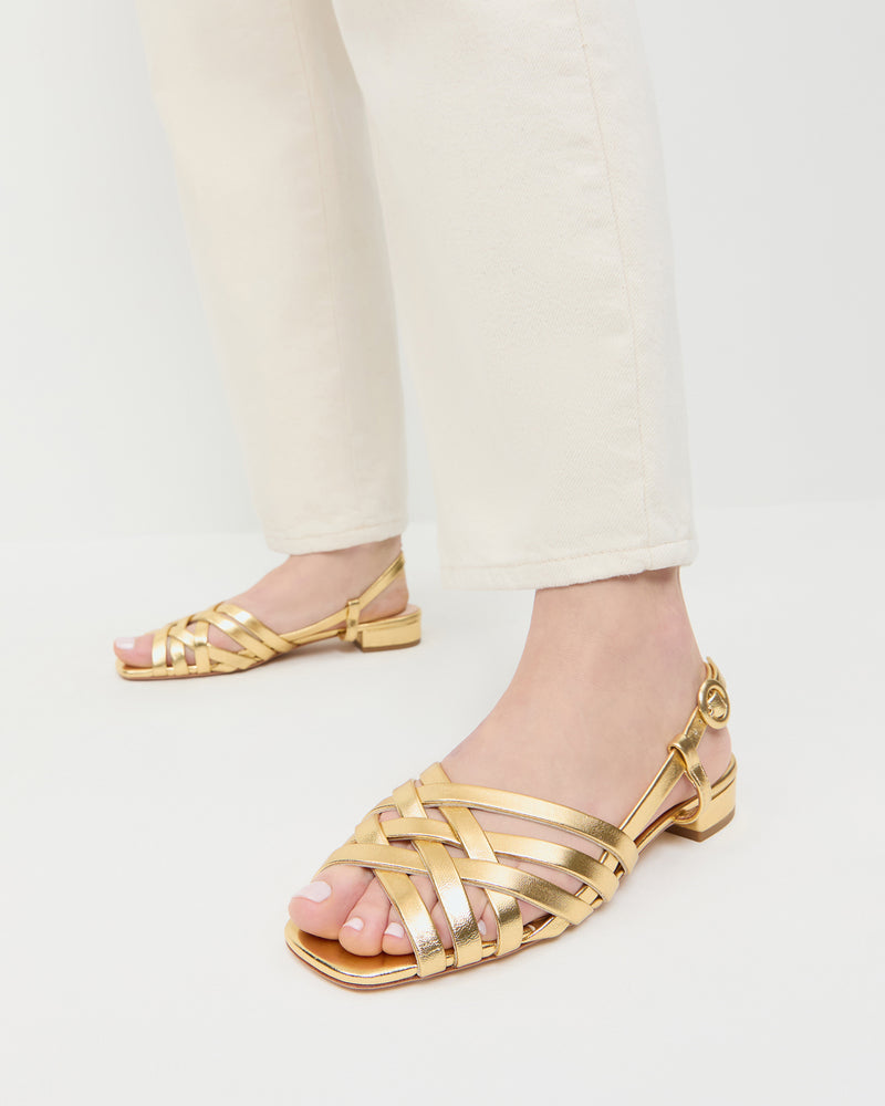 Shelly Gold Leather Flat Sandal in gold metallic leather and Winona Denim Pant in natural denim.