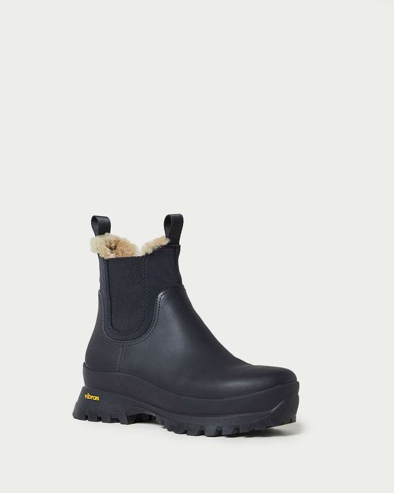 Tara Black Shearling-Lined Boot in black leather.