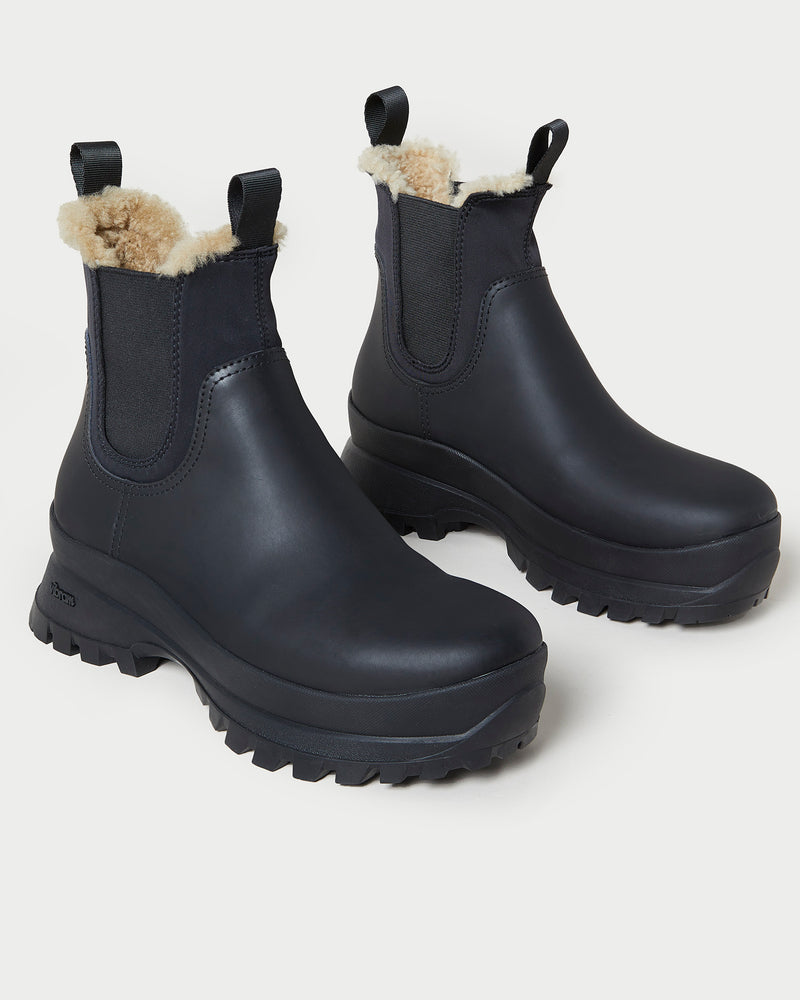 Tara Black Shearling-Lined Boot in black leather.