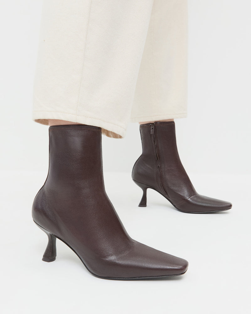 Thandy Brown Leather Curved Heel Bootie in brown leather and Winona Denim Pant in natural denim.