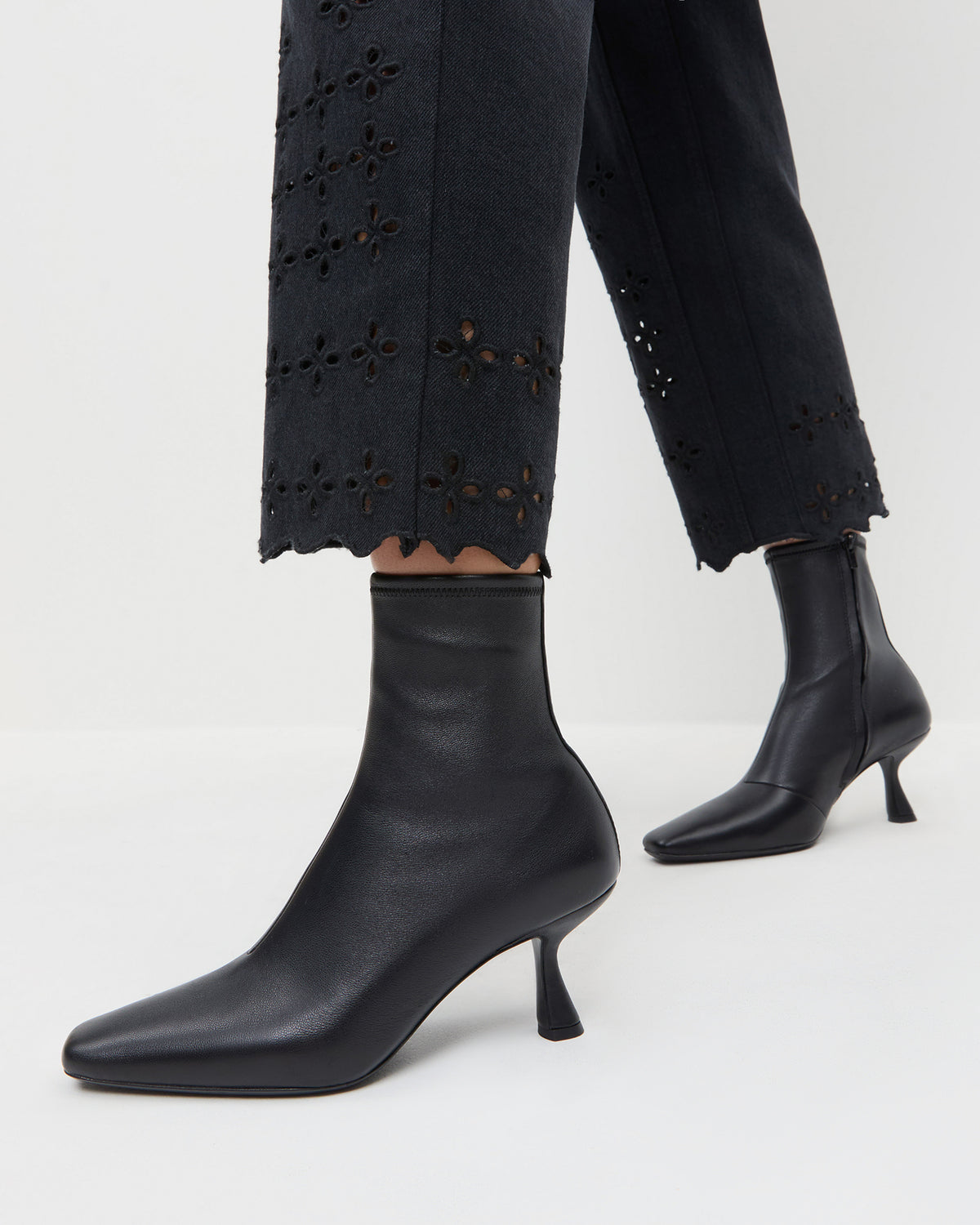 Thandy Black Leather Curved Heel Bootie in black leather and Demi Embroidered Pant in black.
