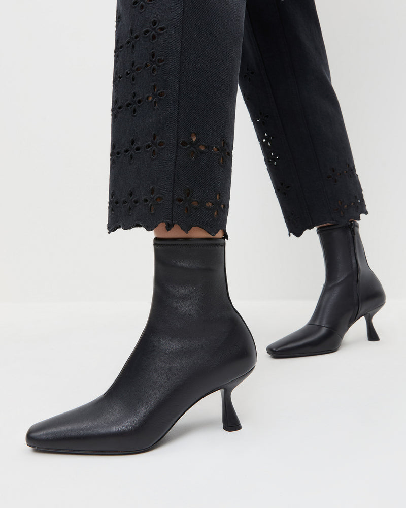 Thandy Black Leather Curved Heel Bootie in black leather and Demi Embroidered Pant in black.