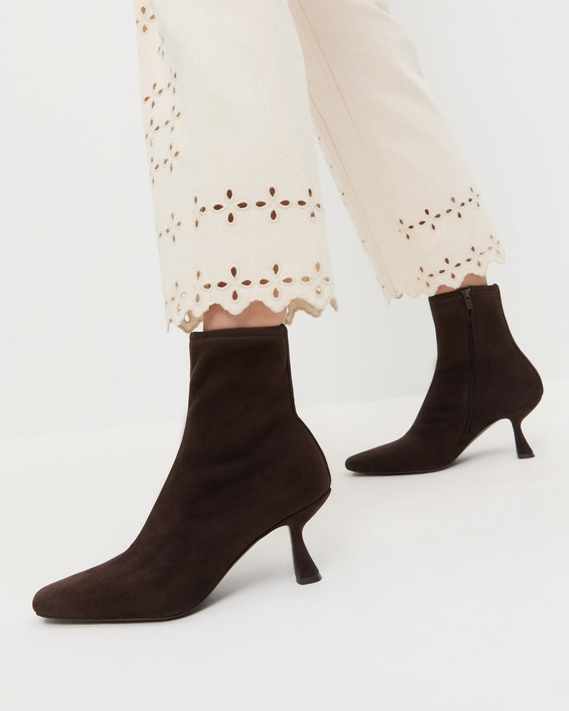 Thandy Brown Suede Curved Heel Bootie in brown suede and Demi Embroidered Pant in natural.
