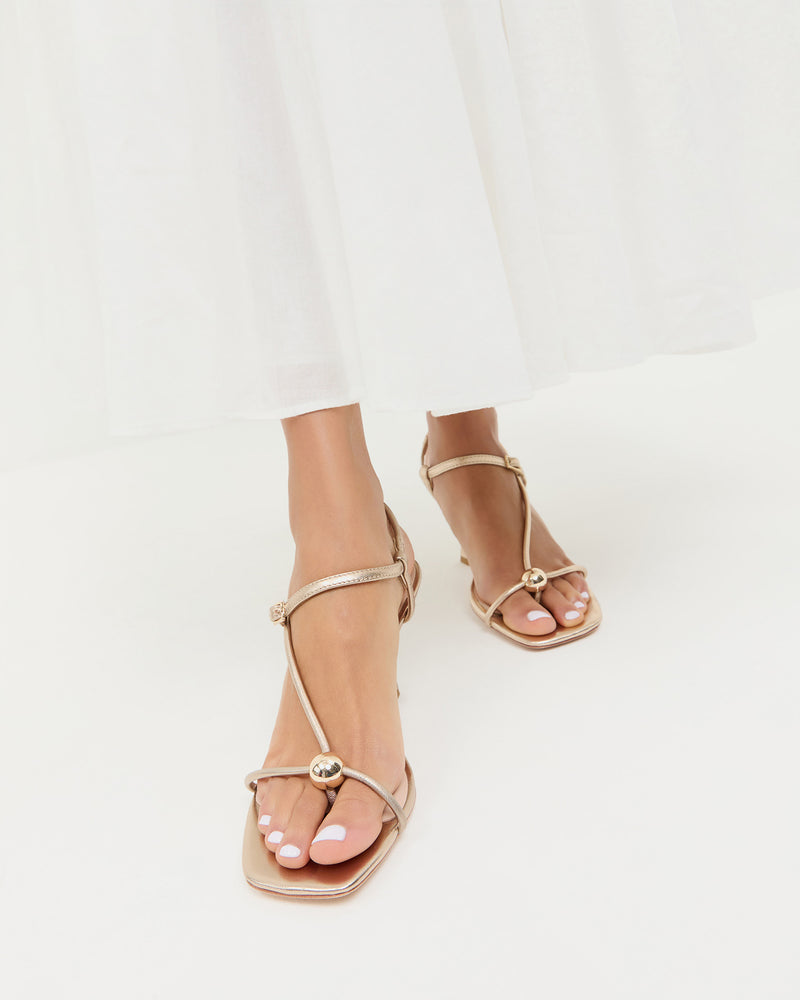 Triana Champagne Leather Mid-Heel Sandal in champagne leather and Clarissa Dress in white cotton.